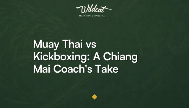 Thai coach guiding a student into clinch position in Wildcat Muay Thai's open-air ring in Chiang Mai