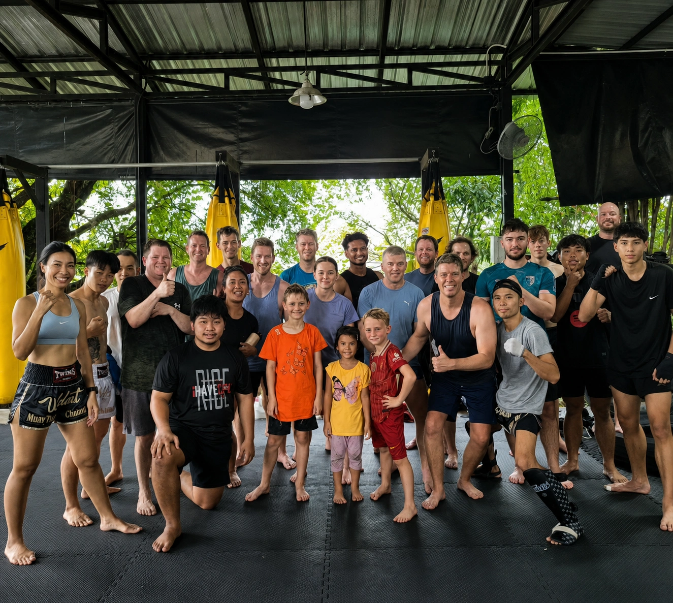 The Wildcat team — coaches and fighters lined up in the open-air gym, Chiang Mai